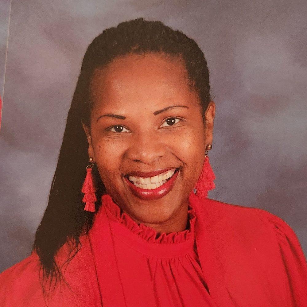 picture of woman wearing red blazer smiling